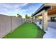 Backyard featuring a covered patio, stone pillars, built in BBQ and artificial turf at 11007 N 26Th St, Phoenix, AZ 85028