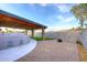 Backyard featuring a covered patio, stone pillars, built in BBQ and artificial turf at 11007 N 26Th St, Phoenix, AZ 85028