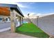 Backyard featuring a covered patio, stone pillars, built in BBQ, pool and artificial turf at 11007 N 26Th St, Phoenix, AZ 85028