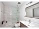 Bathroom with updated fixtures, marble tiling, a soaking tub and a frameless glass shower screen at 11007 N 26Th St, Phoenix, AZ 85028