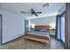 Comfortable bedroom featuring a wood bed frame and access to outdoor space through French doors at 11007 N 26Th St, Phoenix, AZ 85028