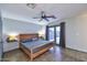 Cozy bedroom with wood bed frame, ceiling fan, and patio access for seamless indoor/outdoor living at 11007 N 26Th St, Phoenix, AZ 85028