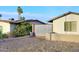 Gravel driveway with metal privacy gate and mature landscaping at 11007 N 26Th St, Phoenix, AZ 85028