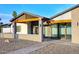 Modern home entrance with stone accents, wooden beams, and a stylish walkway leading to the front door at 11007 N 26Th St, Phoenix, AZ 85028