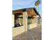 Contemporary home entrance featuring stone and brick accents, wooden beams, and modern glass garage door at 11007 N 26Th St, Phoenix, AZ 85028