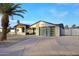 Modern home featuring a sleek design, glass garage door, and ample driveway space with decorative concrete pavers at 11007 N 26Th St, Phoenix, AZ 85028