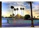 Southwest home with palm trees silhouetted against a vibrant sunset, creating a picturesque desert landscape at 11007 N 26Th St, Phoenix, AZ 85028