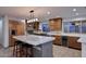 Modern kitchen with sleek wooden cabinets, stainless steel appliances, marble island, and stylish lighting at 11007 N 26Th St, Phoenix, AZ 85028