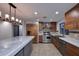 Well-lit kitchen with stainless steel appliances, custom cabinets, and a large marble center island at 11007 N 26Th St, Phoenix, AZ 85028