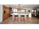Spacious kitchen featuring an island with seating, modern lighting, and stainless steel appliances at 11007 N 26Th St, Phoenix, AZ 85028