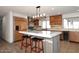 Well-appointed kitchen with an island, stainless steel appliances, and wood cabinetry at 11007 N 26Th St, Phoenix, AZ 85028