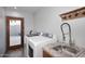 Bright laundry room featuring new appliances, granite countertops, and a sink at 11007 N 26Th St, Phoenix, AZ 85028
