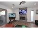 Comfortable living room with a fireplace, flat screen TVs, and hardwood floors at 11007 N 26Th St, Phoenix, AZ 85028