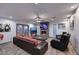 Open concept living area with a fireplace, two TVs, modern furnishings and access to the patio at 11007 N 26Th St, Phoenix, AZ 85028