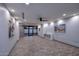 Spacious living room with modern design, featuring wood-look tile flooring, recessed lighting and neutral color palette at 11007 N 26Th St, Phoenix, AZ 85028