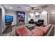 Comfortable living room with fireplace, mounted TVs, modern furniture, and stylish wood-look tile flooring at 11007 N 26Th St, Phoenix, AZ 85028