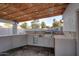 Outdoor kitchen with tile backsplash, built in stainless steel BBQ and storage at 11007 N 26Th St, Phoenix, AZ 85028