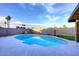 Sparkling in-ground swimming pool surrounded by a white concrete patio and artificial turf at 11007 N 26Th St, Phoenix, AZ 85028