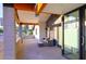 Inviting covered porch with tile flooring, stone pillars, wood accents, and seating area at 11007 N 26Th St, Phoenix, AZ 85028