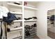 Spacious walk-in closet with built-in shelving, a shoe rack, and hanging rods for ample storage at 11007 N 26Th St, Phoenix, AZ 85028
