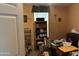View of a bedroom with a window and a shelf unit, with various items around the room at 11411 N 91St Ave # 229, Peoria, AZ 85345