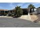 Charming single-story home with covered parking and well-maintained landscaping under a blue sky at 11411 N 91St Ave # 229, Peoria, AZ 85345