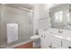 Clean bathroom with glass shower, toilet, and bright white vanity with sink at 12711 W Omega Dr, Sun City West, AZ 85375