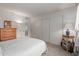Bedroom with closet and door; carpeted floors; white walls; view of side table at 12711 W Omega Dr, Sun City West, AZ 85375