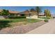 Beautiful single-story home featuring desert landscaping and a well-manicured lawn at 12711 W Omega Dr, Sun City West, AZ 85375