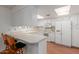 Bright kitchen features white cabinetry, countertops, modern appliances, and skylights at 12711 W Omega Dr, Sun City West, AZ 85375