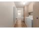 Laundry room with washer and dryer, storage cabinets, and ironing board at 12711 W Omega Dr, Sun City West, AZ 85375