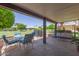 Covered patio area with outdoor seating, grill, and view of the lawn and blue sky at 12711 W Omega Dr, Sun City West, AZ 85375