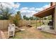 A spacious backyard featuring lush grass, a covered patio, and play equipment at 1344 N Brittany Ln, Gilbert, AZ 85233
