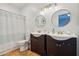 Bathroom with dual sinks and round mirrors providing ample space at 1344 N Brittany Ln, Gilbert, AZ 85233