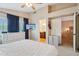 Bright bedroom featuring a ceiling fan, walk-in closet, and ensuite bathroom for added convenience at 1344 N Brittany Ln, Gilbert, AZ 85233