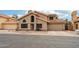 Two-story home featuring a tile roof, neutral stucco, and a two-car garage at 1344 N Brittany Ln, Gilbert, AZ 85233