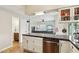 Kitchen featuring tile floors, granite countertops, and view into living room at 1344 N Brittany Ln, Gilbert, AZ 85233