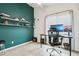 Contemporary office space with custom shelving and a view-enhancing window at 1344 N Brittany Ln, Gilbert, AZ 85233
