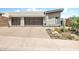 Contemporary home featuring desert landscaping and two-car garage with glass panel doors at 14507 N Valencia Dr, Fountain Hills, AZ 85268