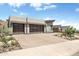 Contemporary home featuring desert landscaping and two-car garage with glass panel doors at 14507 N Valencia Dr, Fountain Hills, AZ 85268