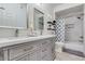 Modern bathroom boasts double sinks, gray cabinets, and a shower-tub combination with stylish tile accents at 15252 N 100Th St # 2157, Scottsdale, AZ 85260