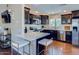 Modern kitchen features dark cabinetry, stainless steel appliances, quartz countertops, and hardwood floors at 15252 N 100Th St # 2157, Scottsdale, AZ 85260