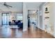 Open-concept living area showcases hardwood floors, leading to a bedroom and bathroom for convenient access at 15252 N 100Th St # 2157, Scottsdale, AZ 85260