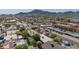 Scenic aerial view of a neighborhood surrounded by mountain landscapes, featuring various residential buildings and lush greenery at 1541 E Cinnabar Ave, Phoenix, AZ 85020