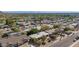 Wide aerial view of a suburban neighborhood showcasing tree-lined streets and residential rooftops, offering a glimpse of community living at 1541 E Cinnabar Ave, Phoenix, AZ 85020