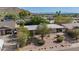 Elevated aerial shot of the desert landscape with a house, a carport and mountain views in the distance at 1541 E Cinnabar Ave, Phoenix, AZ 85020