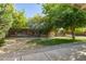 Large backyard featuring mature trees, a wooden fence and patio area at 1541 E Cinnabar Ave, Phoenix, AZ 85020