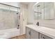 Updated bathroom featuring modern fixtures, gray vanity, and tiled shower over tub at 1541 E Cinnabar Ave, Phoenix, AZ 85020