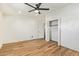 Bedroom featuring wood floors, open closet, whitewashed brick walls, and bright natural light at 1541 E Cinnabar Ave, Phoenix, AZ 85020