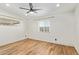 Bright bedroom with light wood floors, whitewashed brick wall, and a ceiling fan at 1541 E Cinnabar Ave, Phoenix, AZ 85020